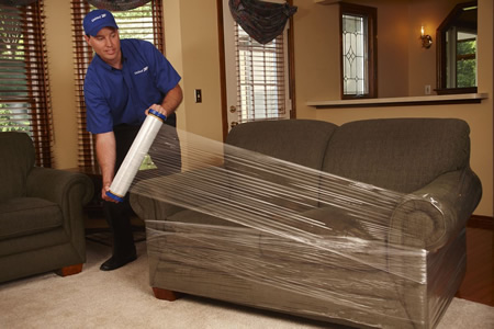 Professional movers loading a sofa into a Mobile, AL home